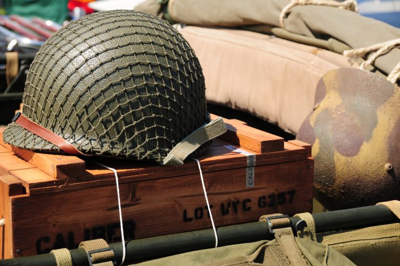 An army helmet atop an ammunition crate