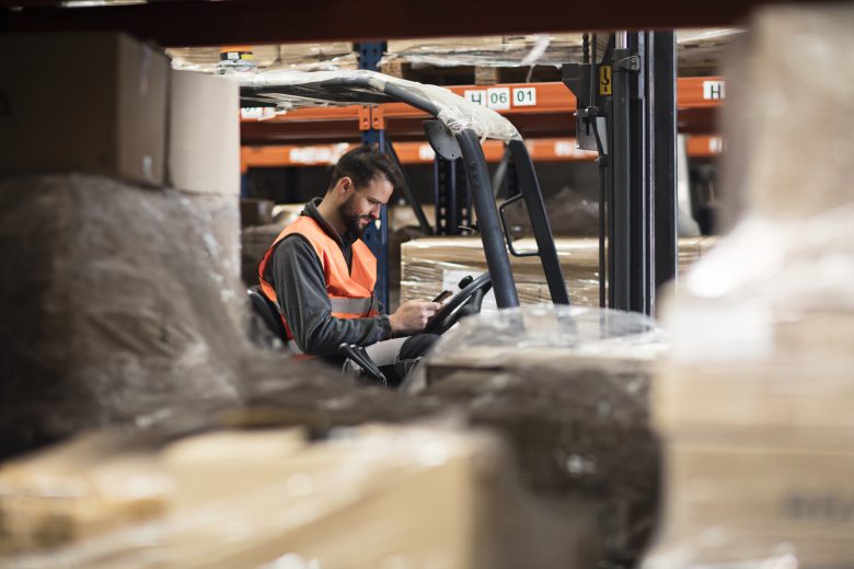 Forklift driver distracted by mobile phone