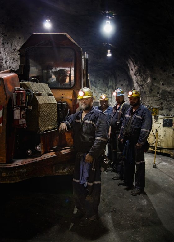 Zinc miners with a 40-ton mine truck, shot at 3100 feet below the surface in the truck maintenance room