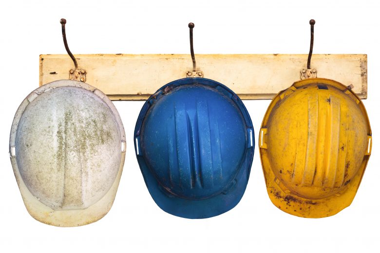 Hard hats hanging on a wall