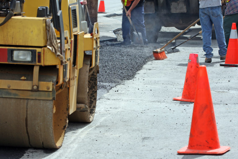 Hot asphalt road work in the hot sun