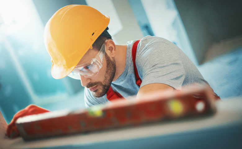 Worker using PPE like hard hat and safety glasses