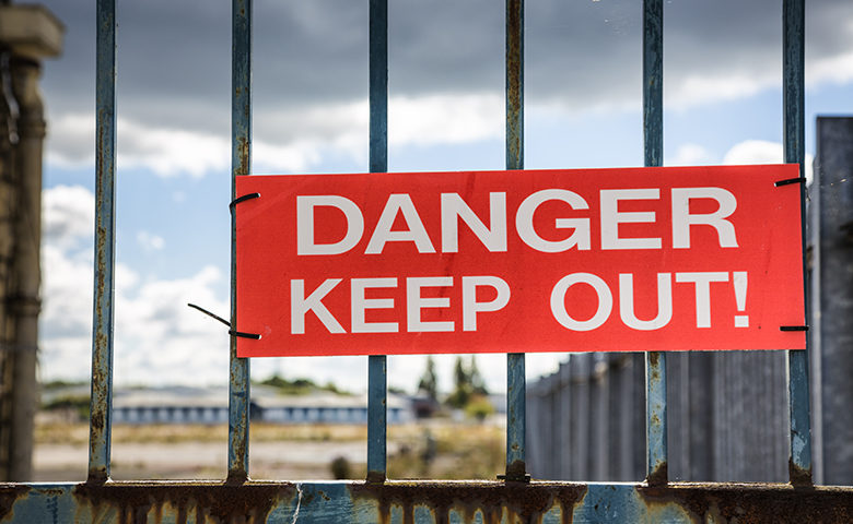 Danger keep out sign on a fence