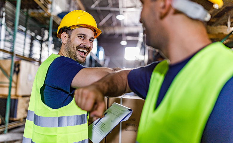 Elbow bump during social distancing in a warehouse!