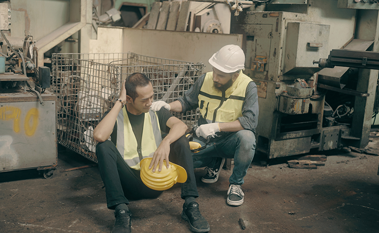 Factory workers try to solve problems with machines.