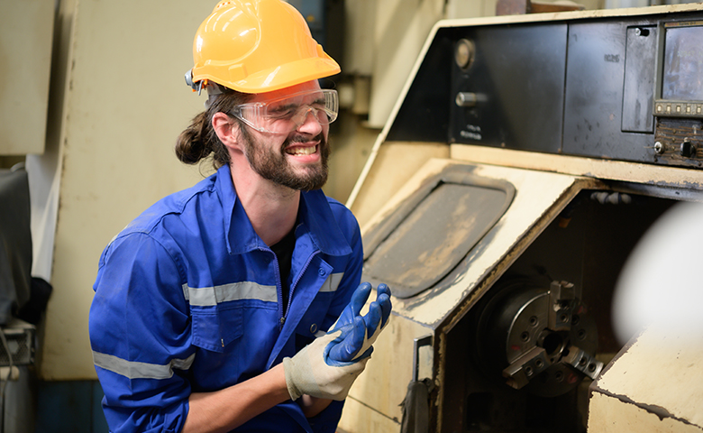 Worker injures hand in industrial setting.