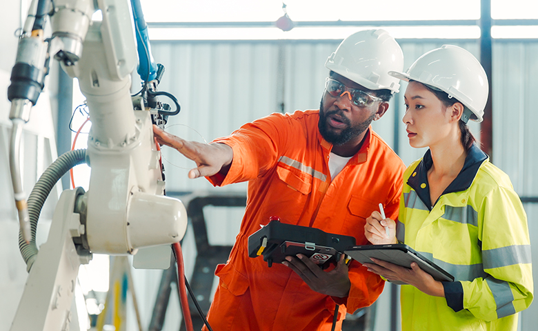 Experienced worker showing new worker the ropes